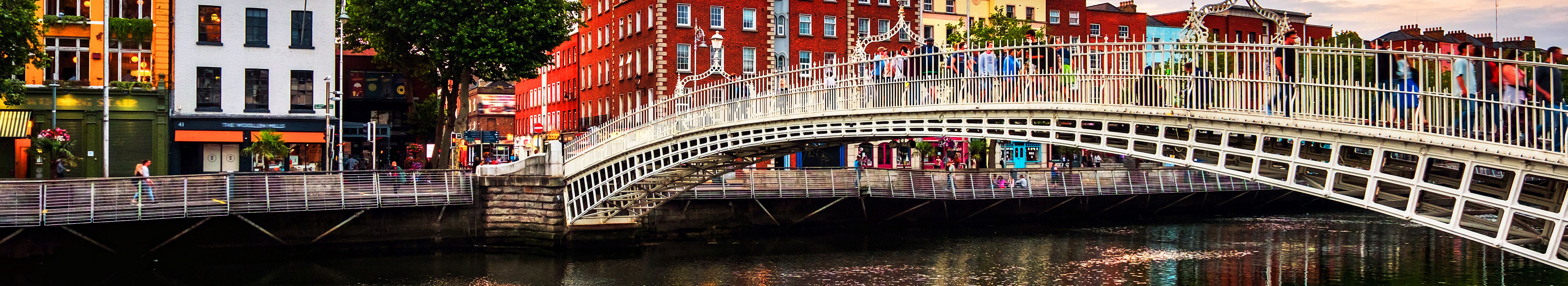 Nachtansicht der berühmten beleuchteten Ha Penny Bridge in Dublin, Irland bei Sonnenuntergang